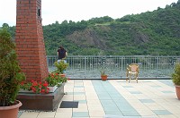  We shared the balcony with three other rooms, but only Sandra and her husband John were next door when we were visiting.  (Note the brick chimney.  It'll give you a reference point later.)