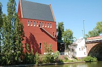  This is just some cool looking building on a little island in the river.