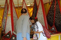  Carolyn and Sandra look over the ubiquitous jewelry at the art-fair-like festival.