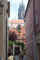  The next mornin we see the towers of the cathedral again, only this time through an alley near the hotel.  The photo is really of the toys hanging above the alley.  You could pull cables on the left wall that would raise and lower where the 